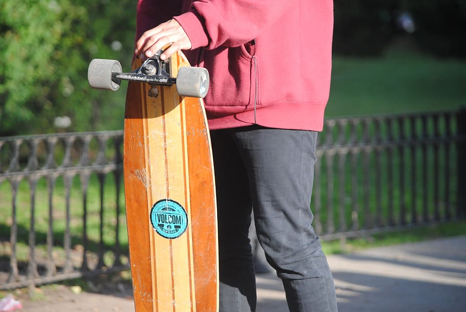 skate, longboard, guy, street, one person, holding, casual clothing, focus on foreground, day, standing