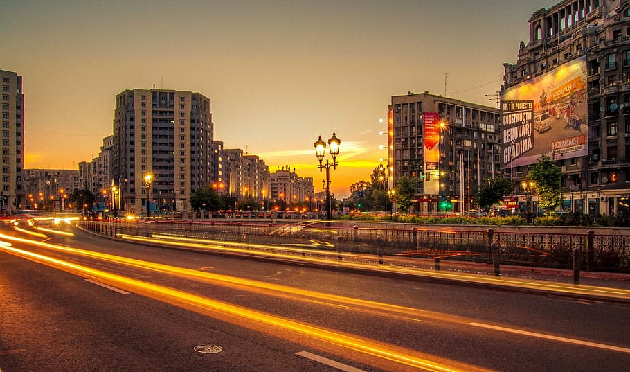 time lapse photography, buildings, city, road, street, cars, lights, sunset, dusk, lamp posts