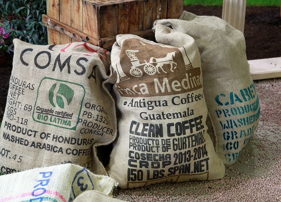 three assorted-labeled sacks, coffee, coffee bag, bags, text, western script, communication, indoors, close-up, sack