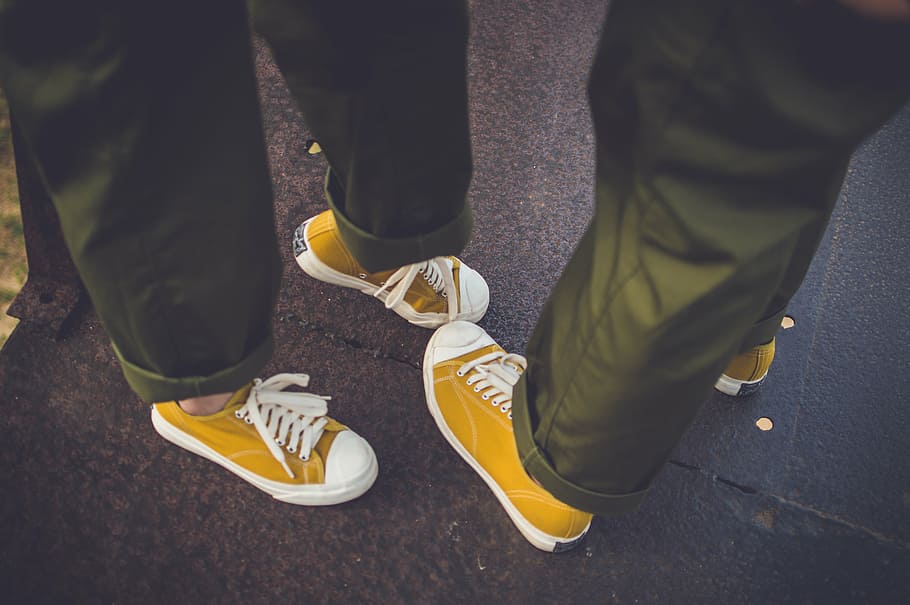 matching, pairs, yellow, low-top sneakers, person, wearing, white, low, top, sneakers