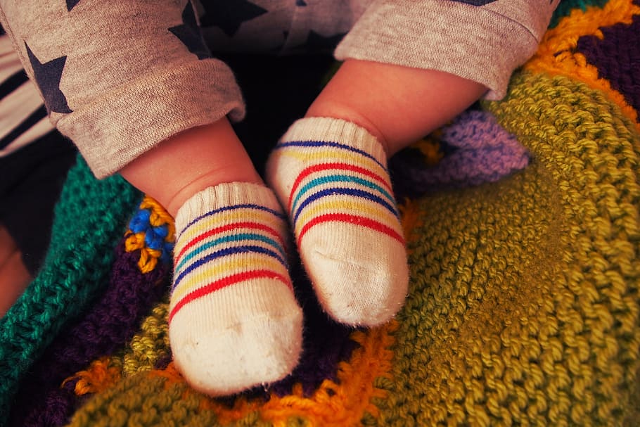 baby, wearing, pair, red-blue-yellow-and-white socks, baby feet, socks, small, cute, child, human body part