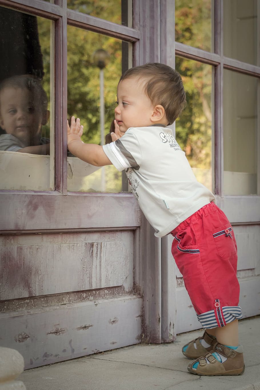 child, facing, smoke-glass window, baby, cute, kid, plays, boy, toddler, small child