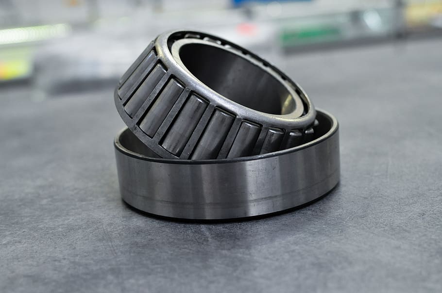 tapered roller bearing, bearings, bearing, maintenance, machine parts, metal, selective focus, close-up, focus on foreground, alloy
