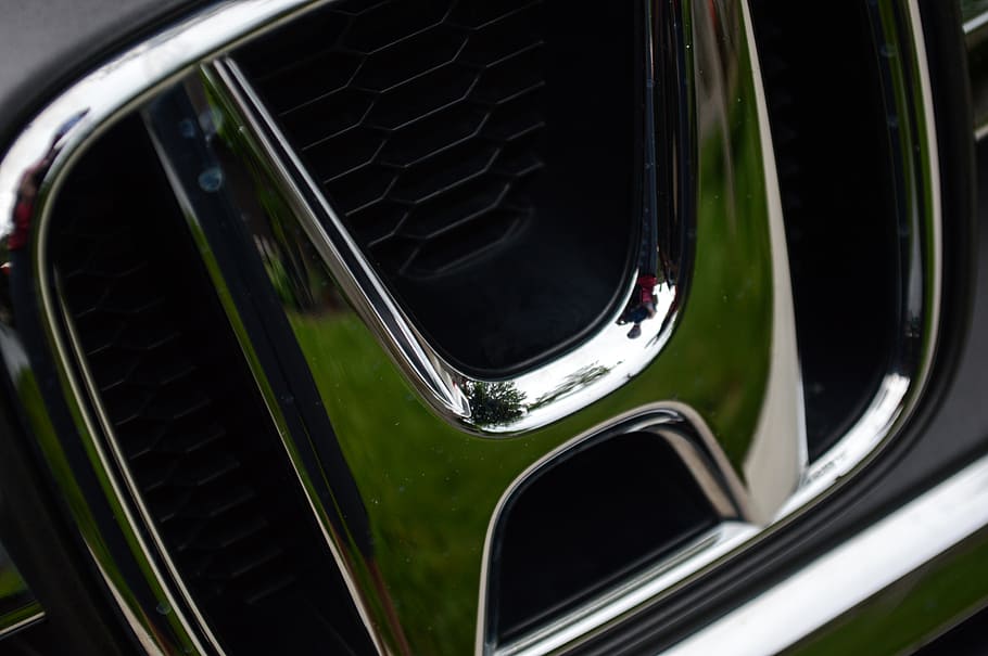Honda emblem, mode of transportation, motor vehicle, car, transportation, close-up, land vehicle, metal, reflection, shiny