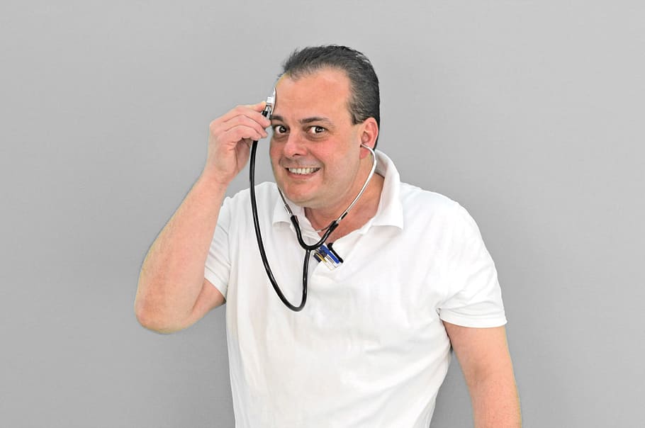 person, wearing, white, polo shirt, holding, stethoscope, putting, forehead, doctor, crazy
