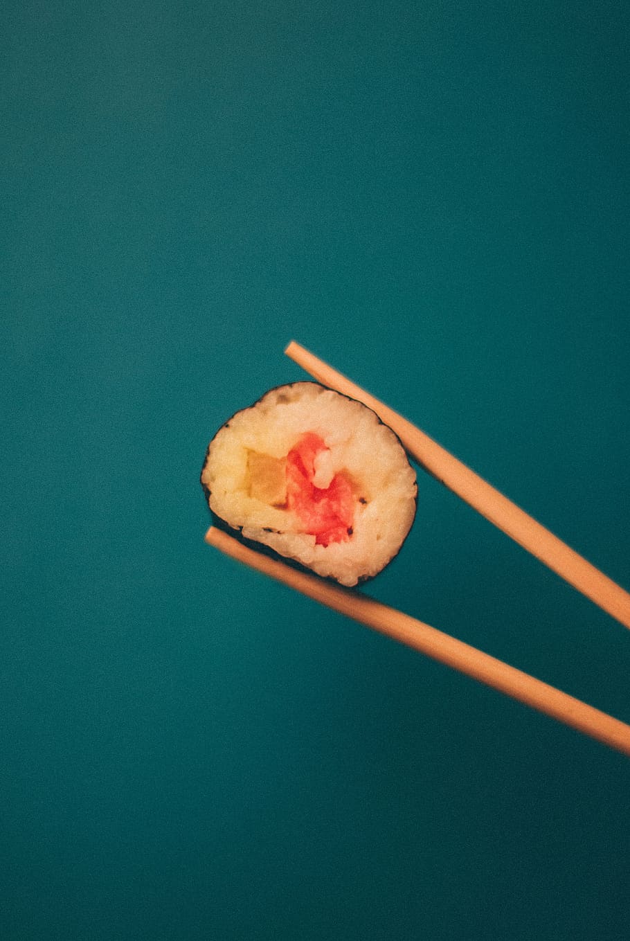 person, holding, chopsticks, sushi, tuna, brown, wooden, chop, sticks, maki