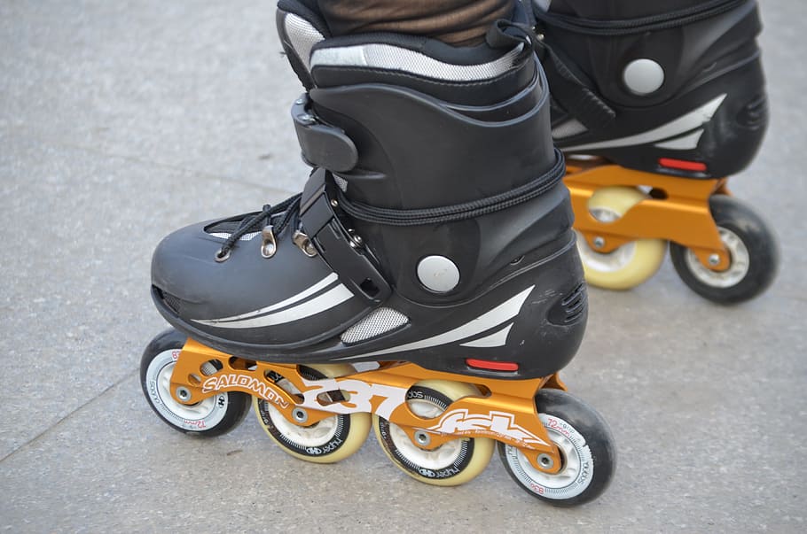 person, wearing, black-and-orange, inline skates, Rollerblade, Skate, Boots, skating, equipment, sports