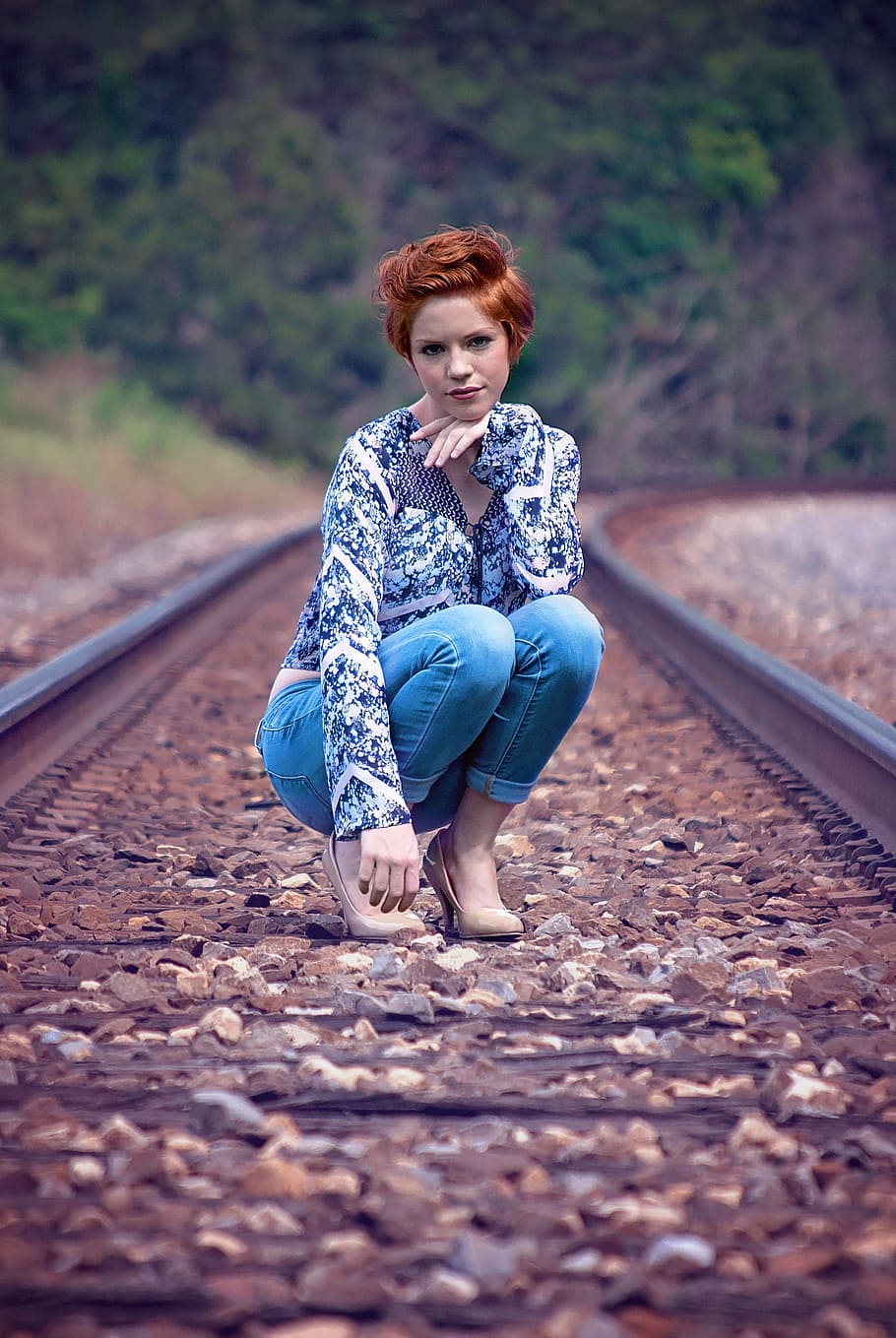 woman, blue, long-sleeved, top, jeans, train railings, girl, pose, squatting, young