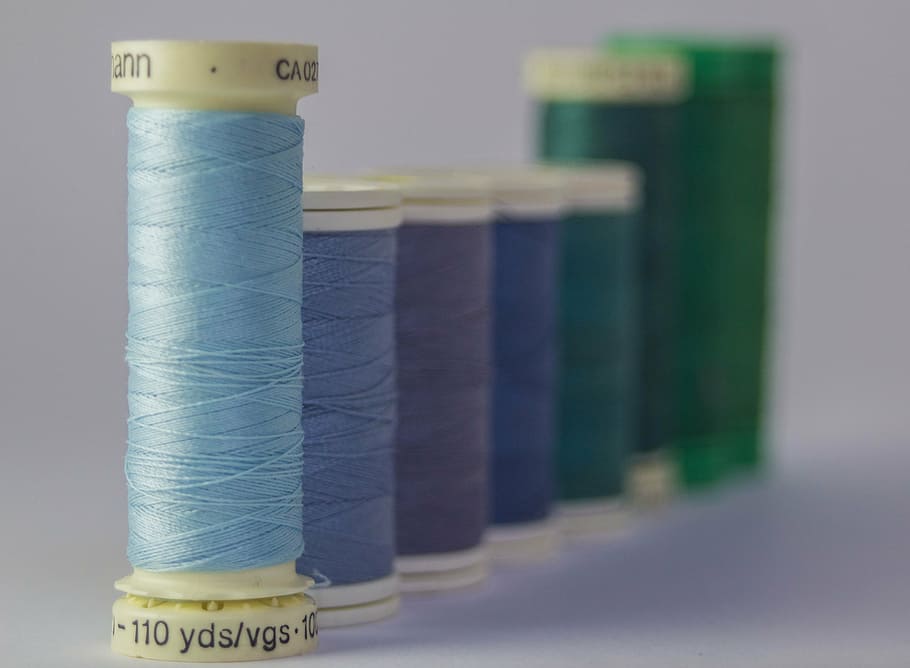 assorted-color threads, assorted, treads, spools, threads, colors, row, queue, sewing, materials