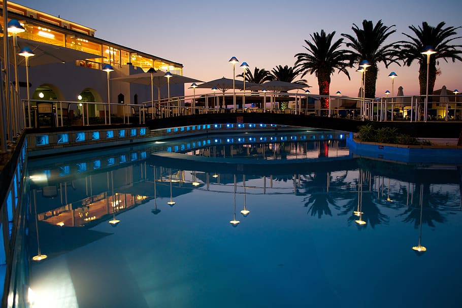blue swimming pool, hotel, pool, swimming pool, reflection, palm tree, crete, water, sunset, architecture