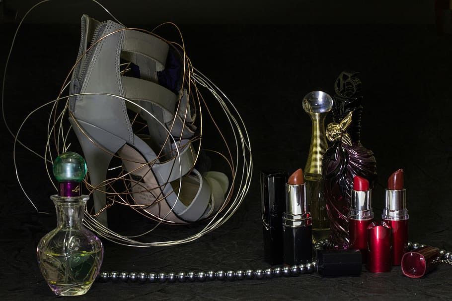 four lipstick bottles, still life, lipsticks, perfumes, beads, shoe, high heeled shoe, indoors, table, variation
