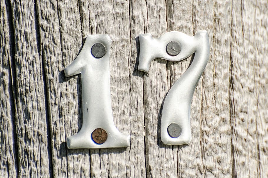 gray 17 signage, numbers, 17, metal numbers on post, wooden post, metal, lettering, sign, symbol, seventeen