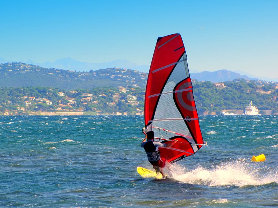 man playing sailboat, windsurf, windsurfer, aquatics, south of france, saint-tropez, sport, water, sea, mountain