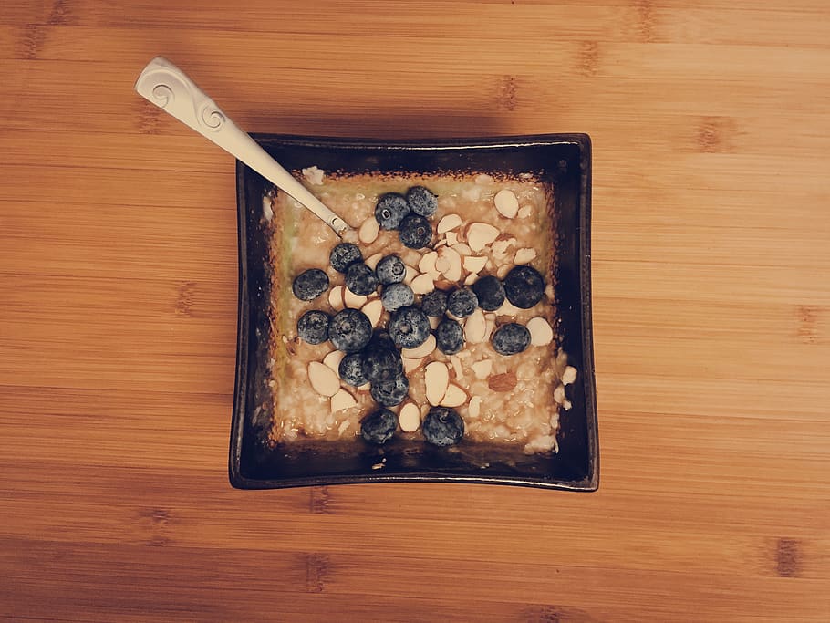 oatmeal, blueberries, almonds, breakfast, food, spoon, bowl, food and drink, table, freshness