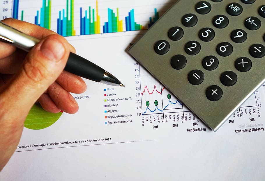 person, holding, silver pen, office, pen, calculator, computation, data, chart, financial