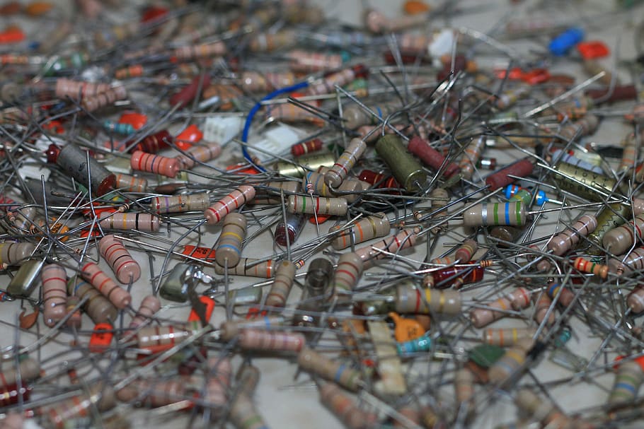 assorted-color capacitor lot, electronics, components, resistors, capacitors, technology, selective focus, day, close-up, large group of objects