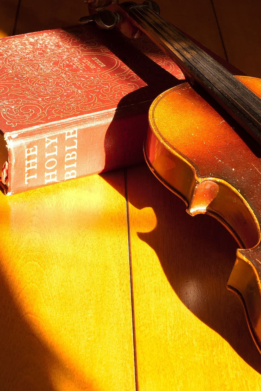 bible, fiddle, music, vintage, close-up, string instrument, indoors, sunlight, shadow, arts culture and entertainment