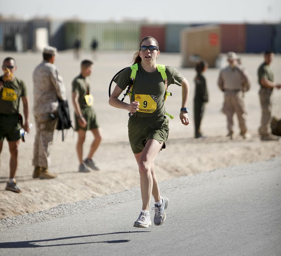 selective, focus photography, woman, running, roadway, daytime, runner, marathon, military, afghanistan