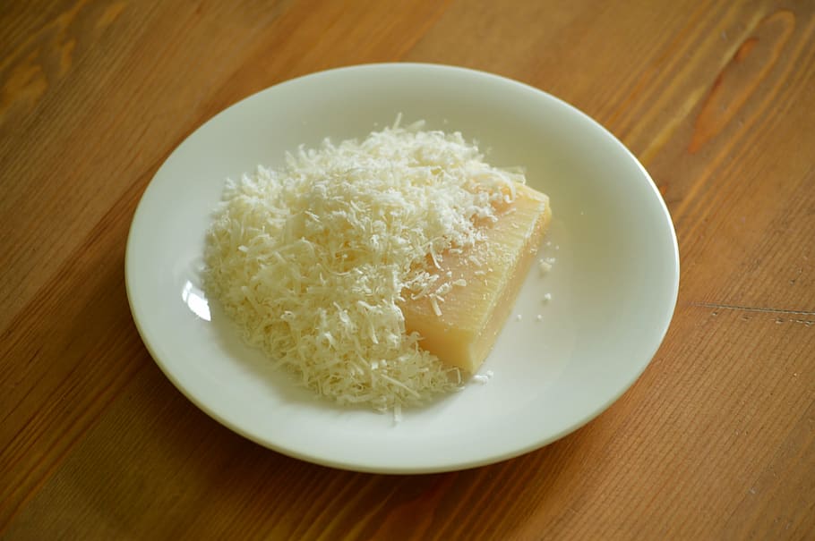 rice cake, round, white, plate, parmesan, cheese, grated, shredded, block, food