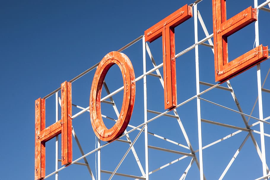 hotel, sign, letters, orange, blue, sky, text, clear sky, low angle view, architecture