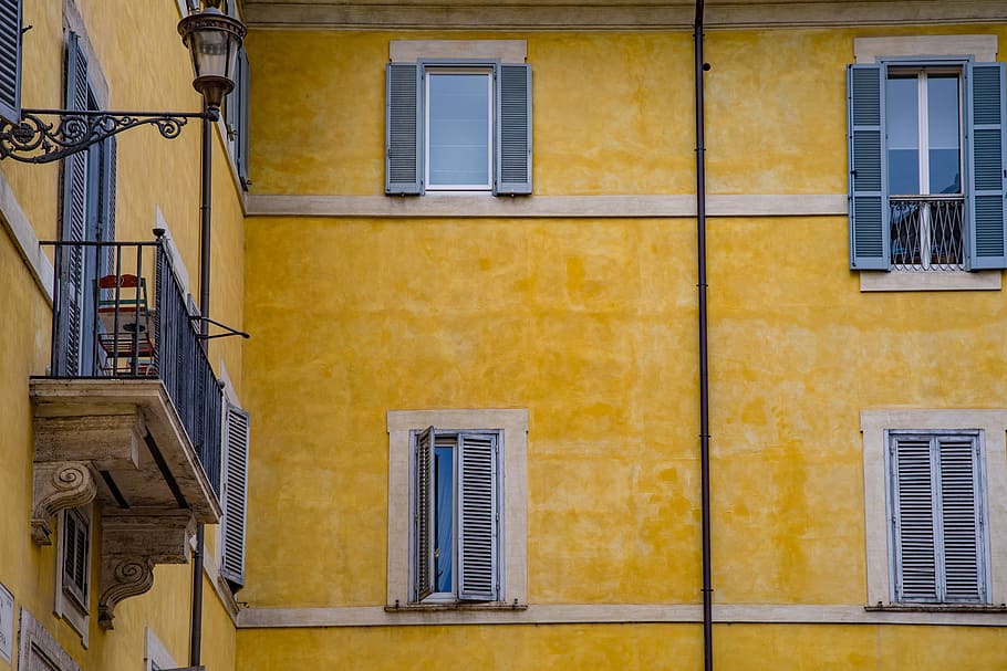 yellow concrete buidling, facade, window, balcony, architecture, italian, roman, building, house, colorful