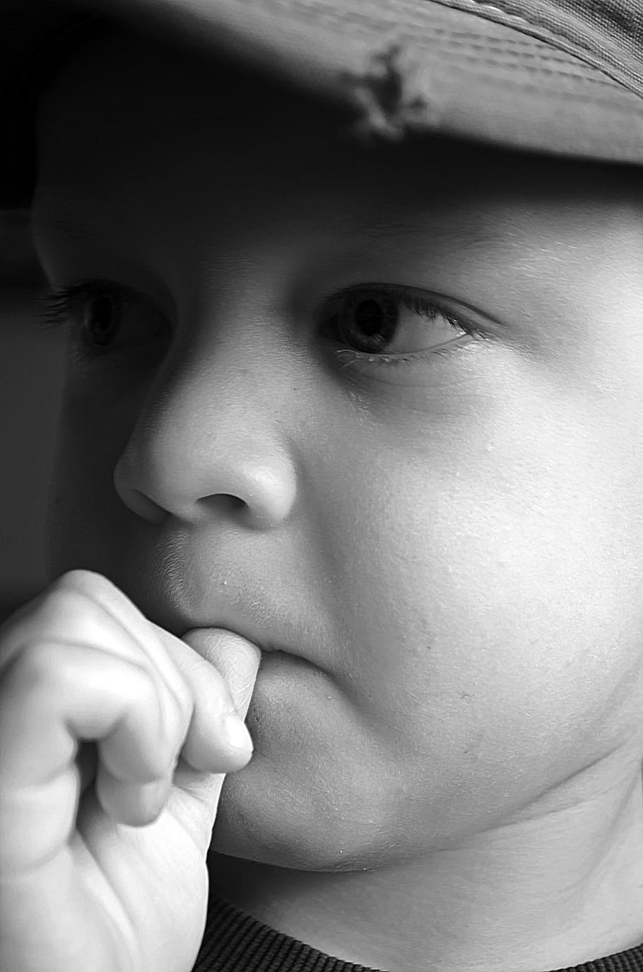 grayscale photography, boy, wearing, cap, thumb, mouth, sad, child, kid, young