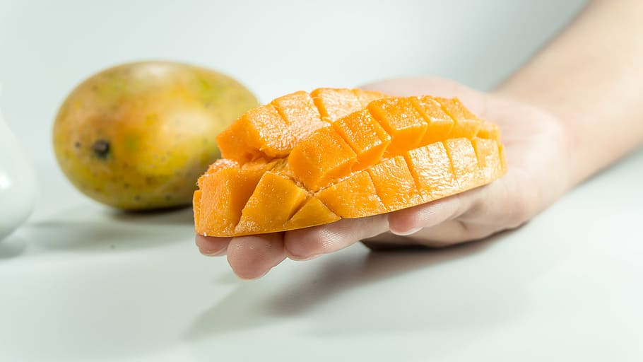 slice mango, person, hand, mango, slice, on hand, yellow, isolated, cube, fruit