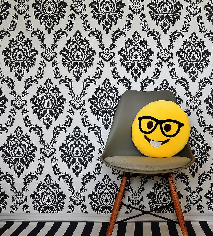 yellow, emoji pillow, brown, wooden, framed, gray, padded, chair, laugh, smiley