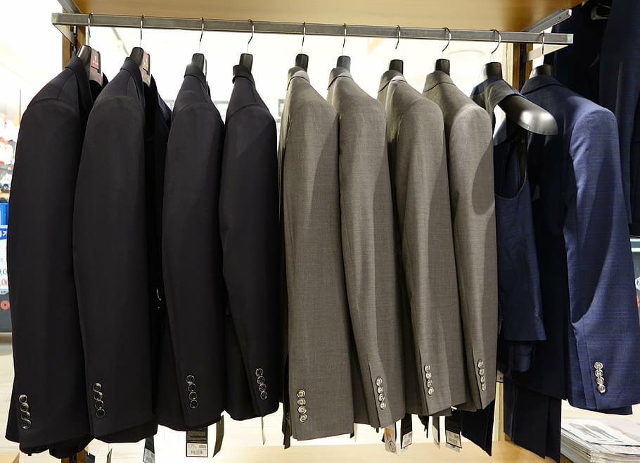 assorted-color suit jackets, suit, dress up, menswear, in-store, clothing, jacket, department store, shopping, display cases