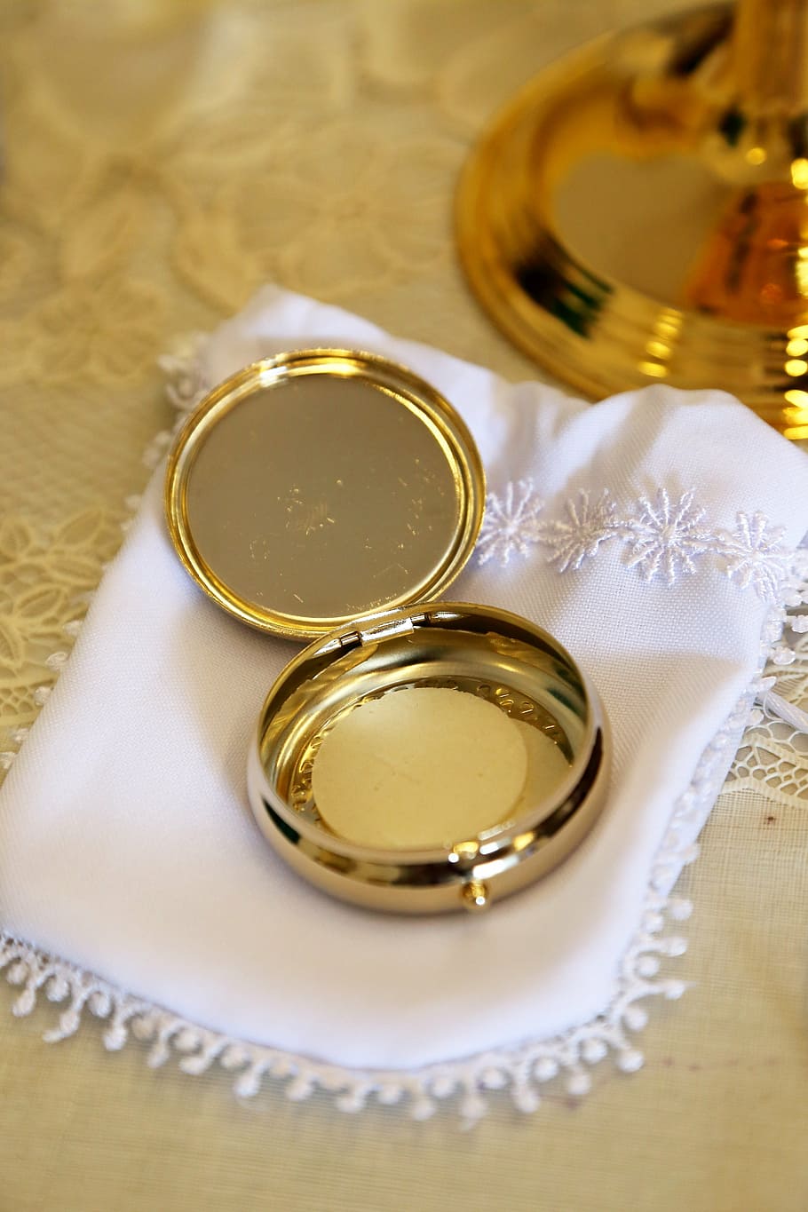 round gold-colored case, eucharist, host, communion, catholic, religion, christ, christian, christianity, sacrament