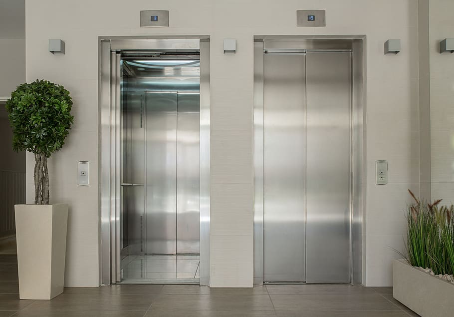 two grey elevators, elevators, lobby, entrance, new building, interior, interior design, renewal, renovations, door