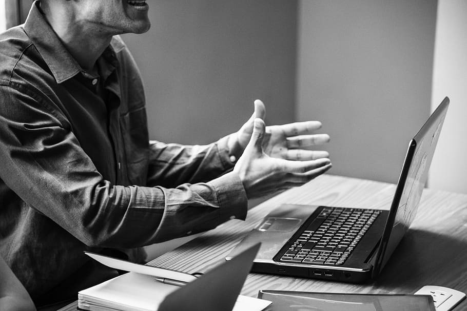 grayscale photography, man, sitting, chair infront, laptop, american, black and white, brainstorming, business, businessman