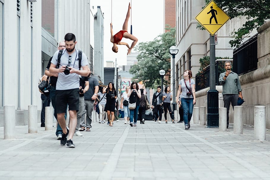 montage, trapeze artist, acrobat, pedestrians, road, street, city, urban, architecture, group of people