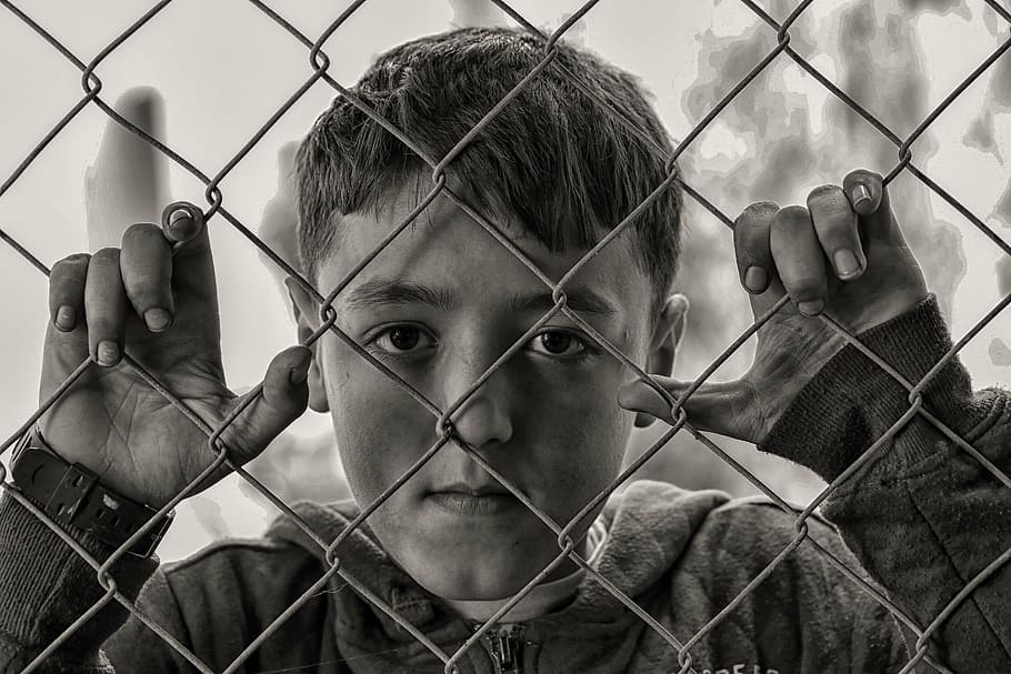 boy, chain-linked fence, hungry, sad, chainlink fence, protection, safety, one person, adults only, headshot