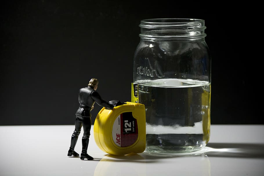 luke skywalker action figure, placed, next, 12-feet, yellow, ace steel tape, clear, liquid, half-filled, glass jar
