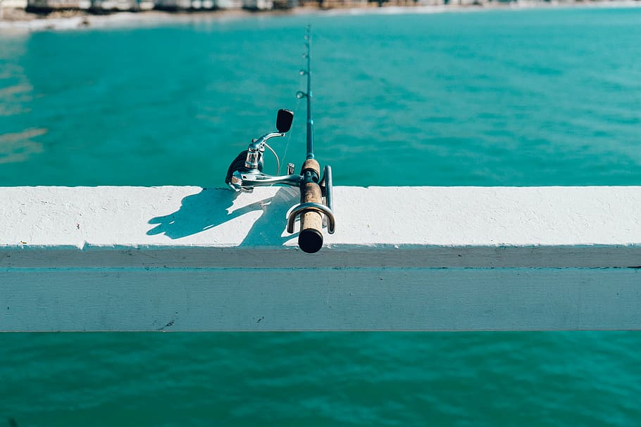 brown, black, fishing rod, close, fishing, rod, white, railing, pier, water