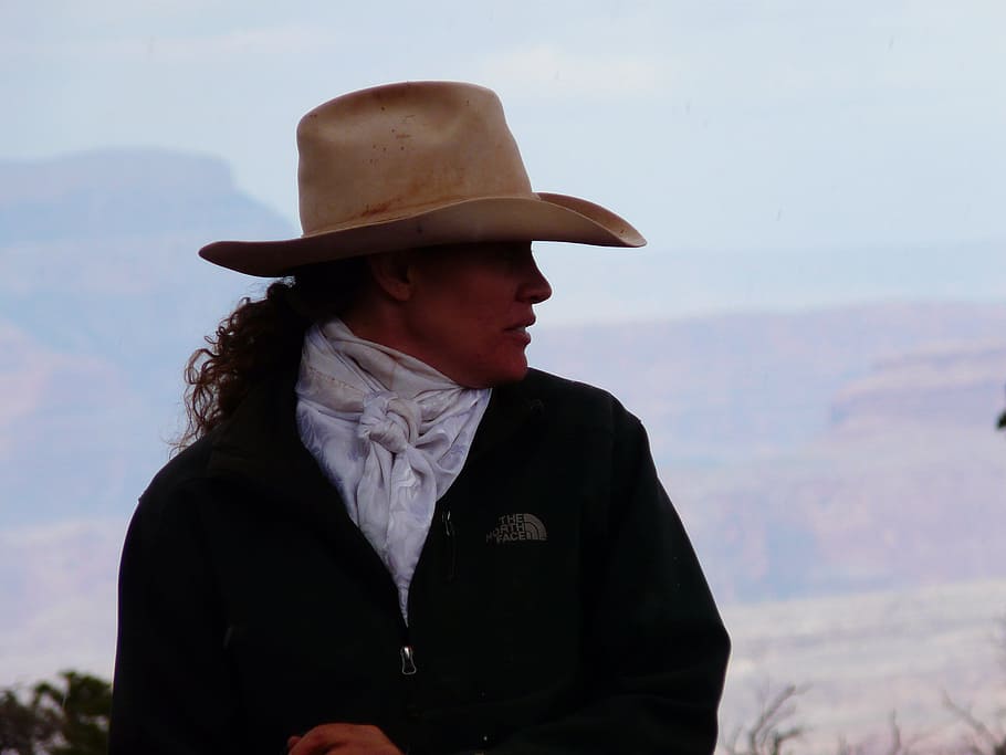 woman, black, north, face jacket, wearing, brown, cowboy hat, daytime, woman in black, The North Face