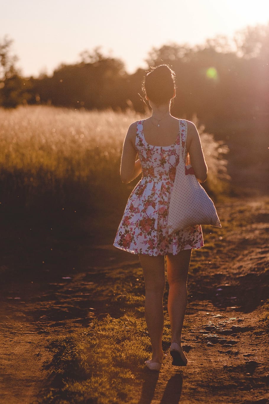 woman, walking, dirt road, golden, hour, white, red, floral, dress, hobo