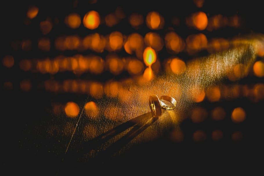 gold-colored rings, alliances, against light, lighting, double exposure, marriage, illuminated, water, close-up, night