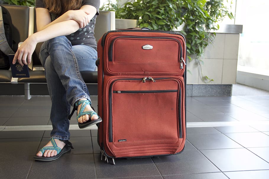 woman, sitting, red, travel luggage, travel, suitcase, airport, luggage, journey, trip