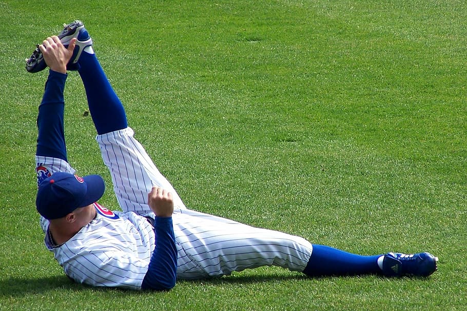 mlb player, stretching, field, chicago, cubs, baseball, grass, real people, lifestyles, lying down