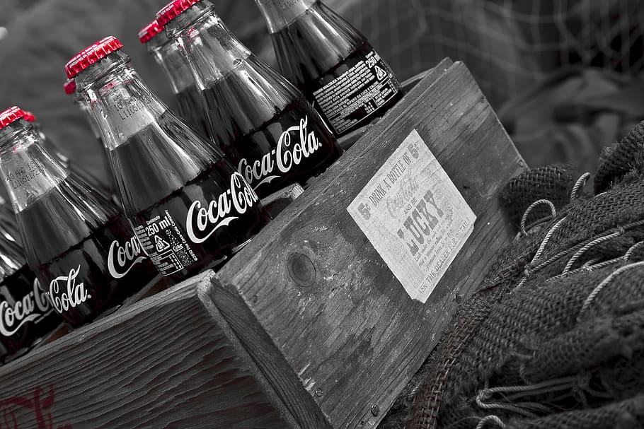 coca cola, drink, bottle, text, communication, western script, high angle view, table, still life, indoors
