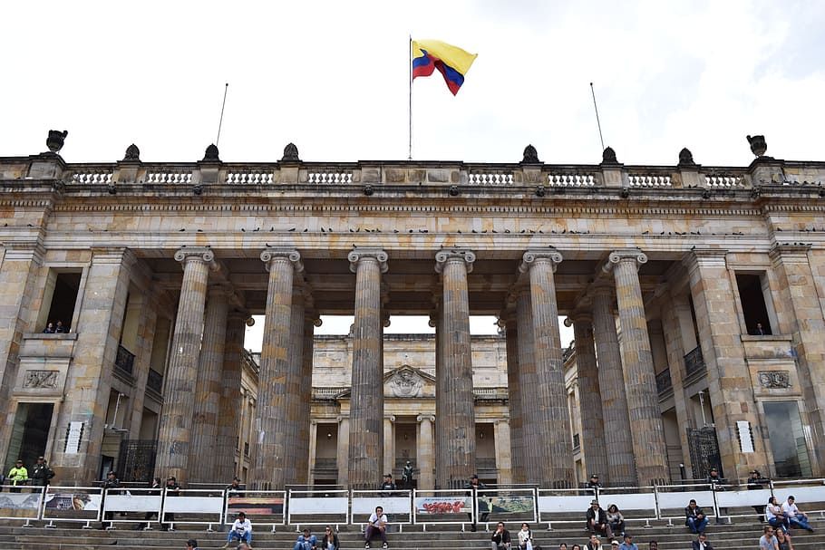 low-angle photo, spain flag, brown, concrete, museum, white, sky, Bogota, Bogotá, Colombia