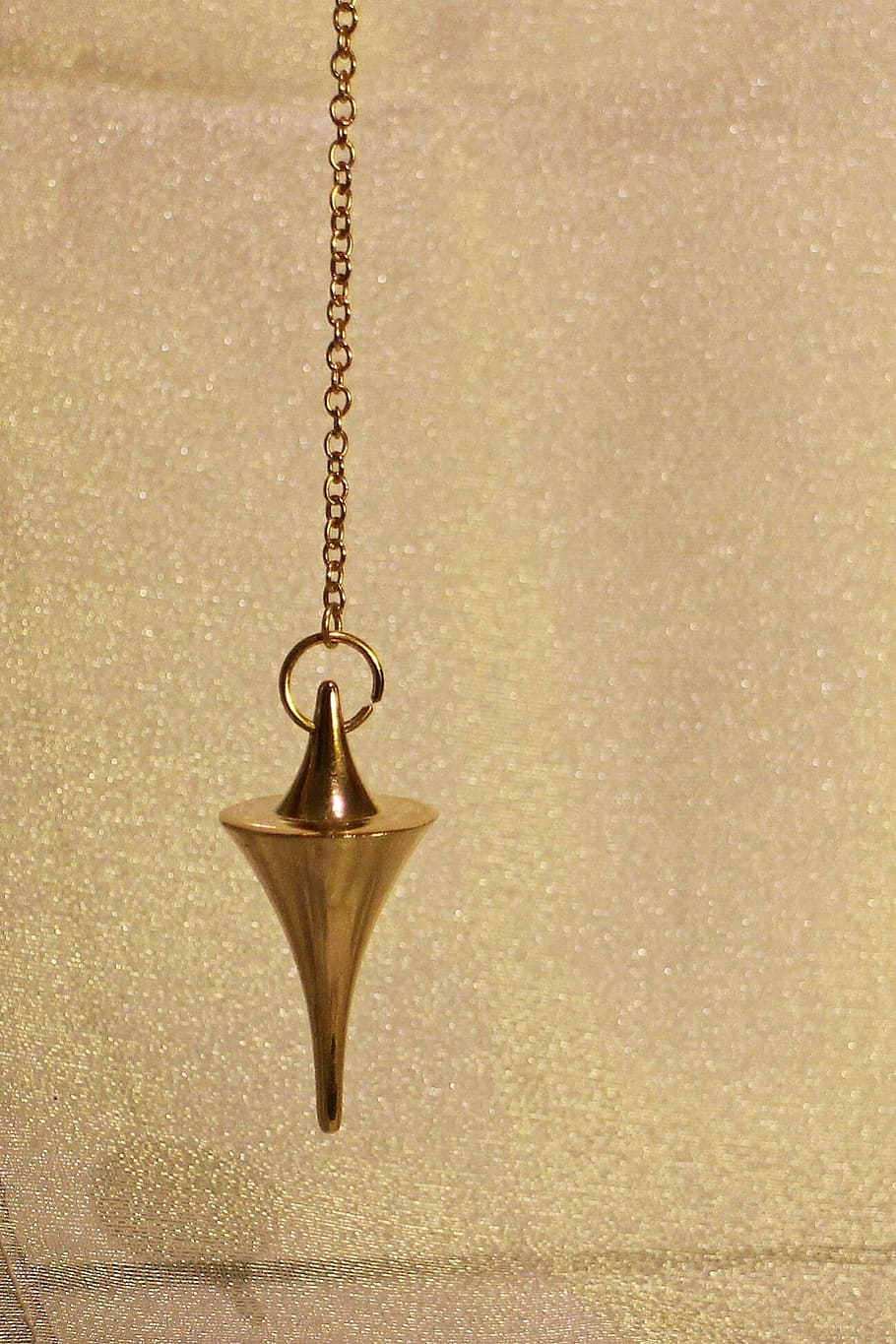 gold-colored pendulum, pendulum, commute, lot, cone, conical, metal, metal piece, tool, tools