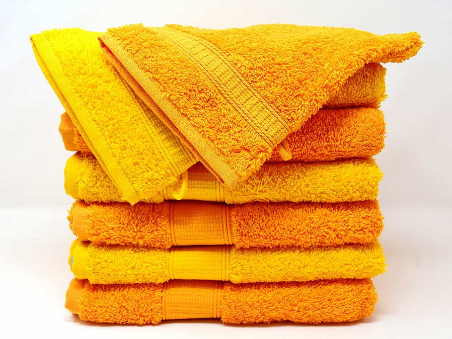 stacked yellow towels, towels, washcloth, yellow, orange, colorful, structure, color, soft, tissue