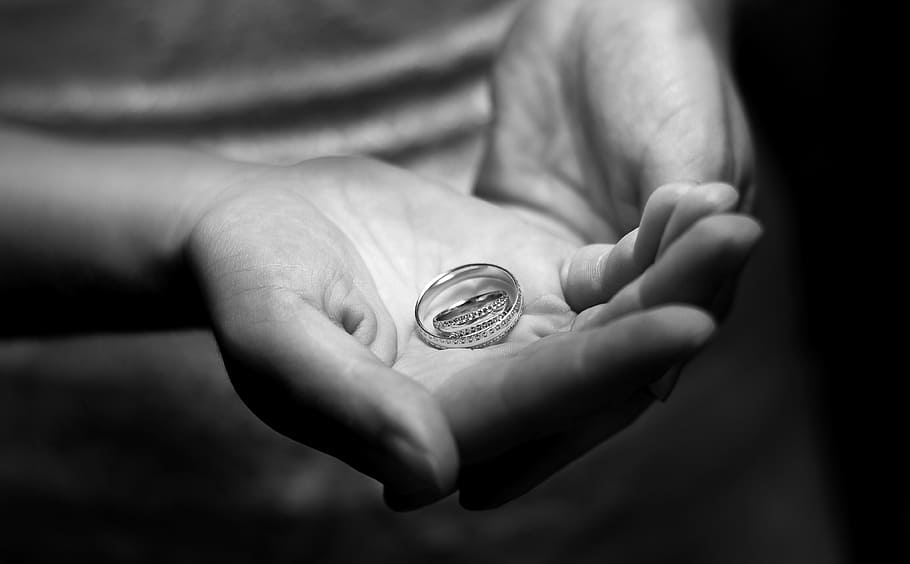person holding ring, ring, hands, engagement, fingers, finance, human hand, hand, human body part, coin