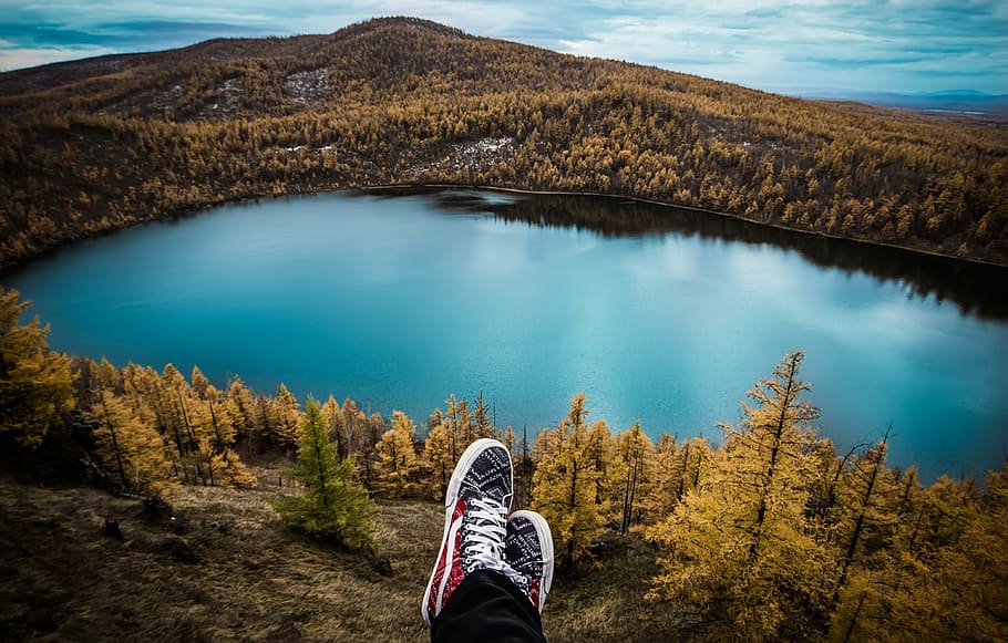 person, wearing, red-and-white, sneakers, sitting, front lake, travel, aershan, shoes, lake