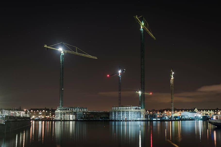 tower cranes, body, water, view, city, night, architecture, buildings, infrastructure, sky