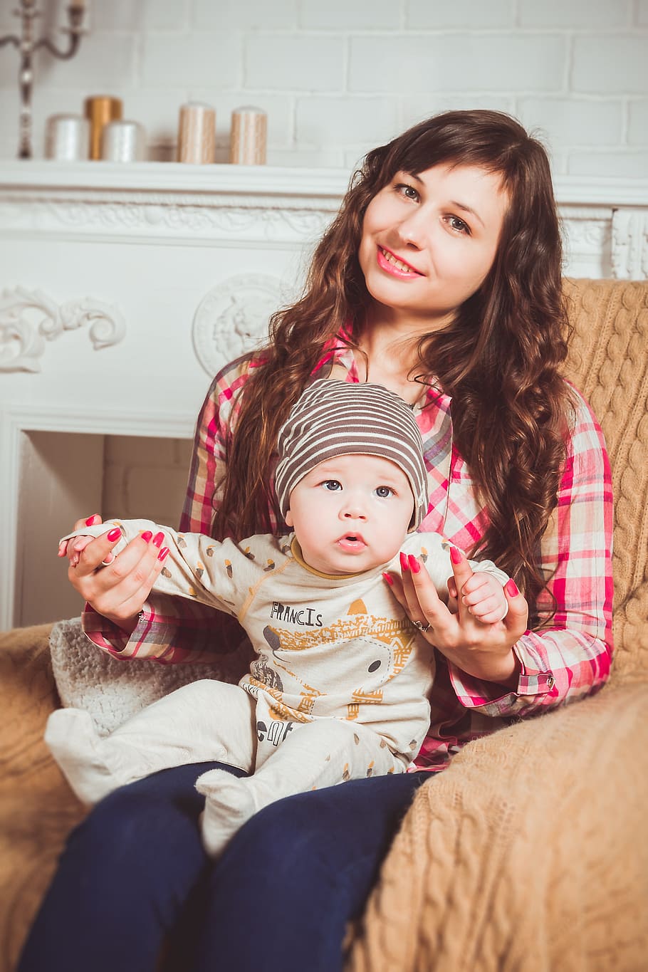 woman, red, brown, plaid, dress shirt, holding, baby, family, photoshoot, armchair