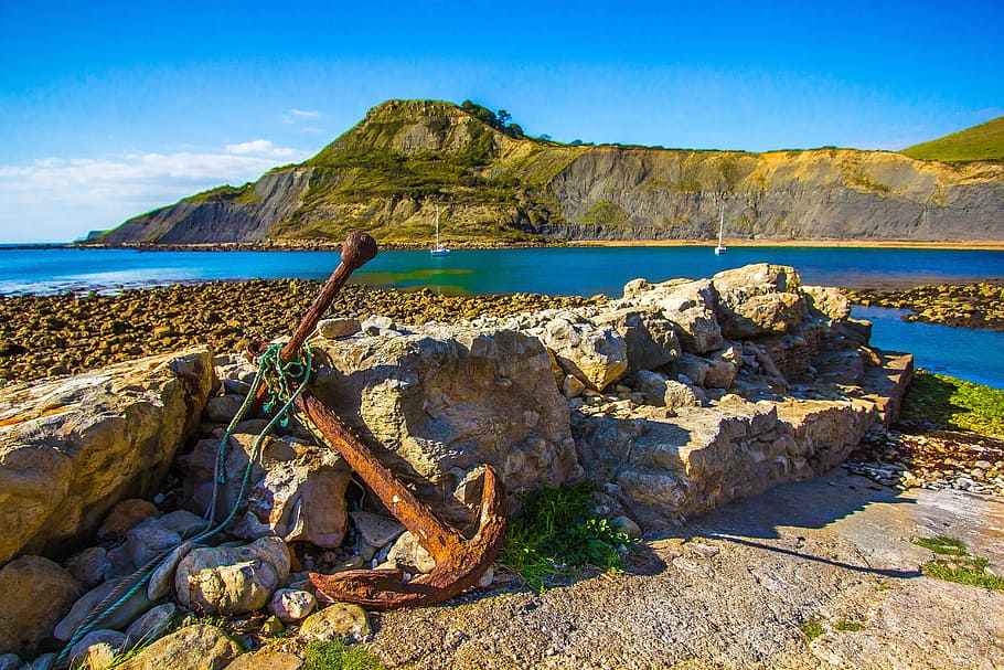 brown, metal anchor, gray, rock, metal, anchor, gray rock, ocean, dorset, jurassic coast